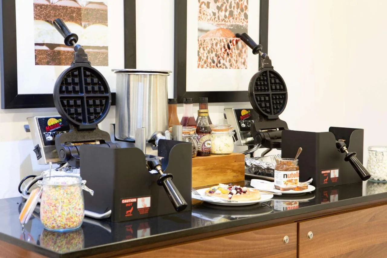 a restaurant counter with food on top of it at Hampton by Hilton York in York
