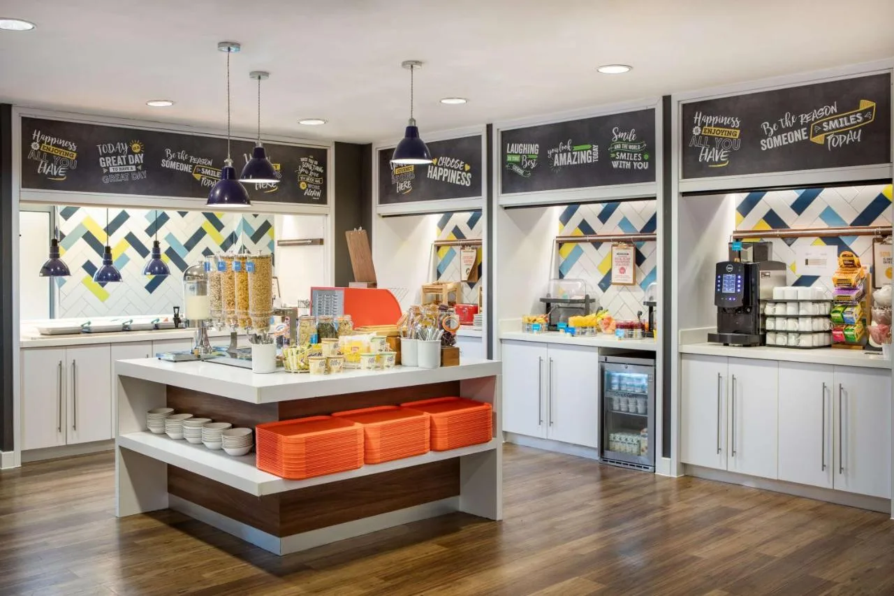 a kitchen with white cabinets and a counter at Hampton by Hilton York in York