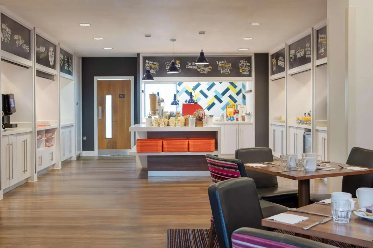 a restaurant with a table and chairs and a counter at Hampton by Hilton York in York